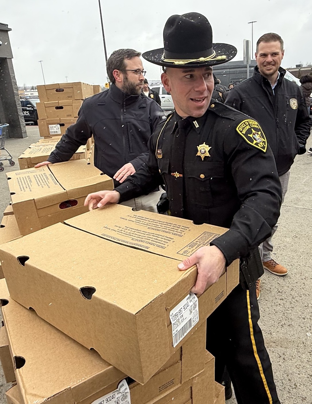 Members of the Broome County Sheriff’s Office distributing 700 turkeys to help Catholic Charities of Broome County feed local families over Thanksgiving.